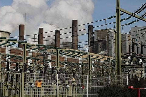 Several powerlines on metal structures at a power grid