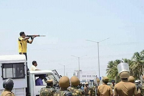 A person stands on the top of a vehicle to shot protesters against the Sterlite plant in Thoothukudi in May 2018 