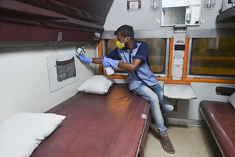A worker cleaning a train compartment: Bomb threat calls on two Mumbai-bound trains in Telangana prove to be hoax
