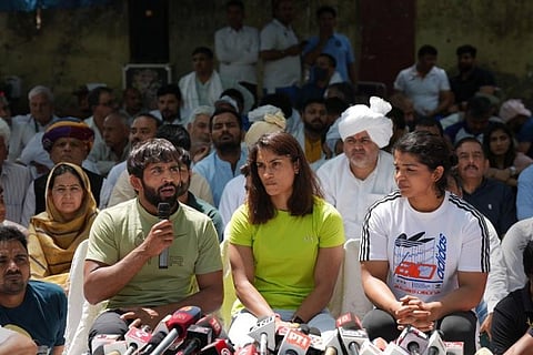 Protesting wrestlers addressing media