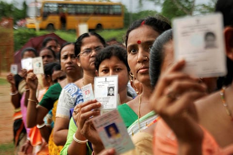 Voters standing in queue outside a polling booth 