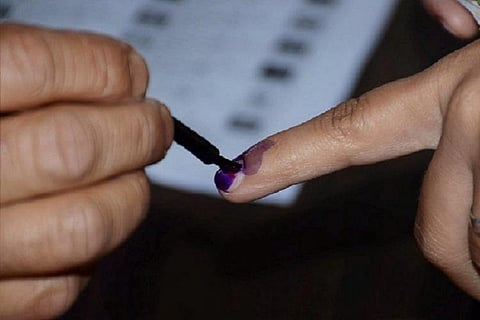 Indelible ink being applied to a voter