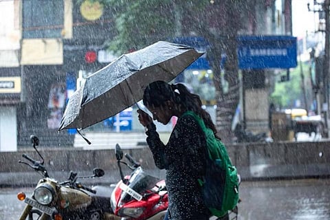 Woman walking in heavy rain
