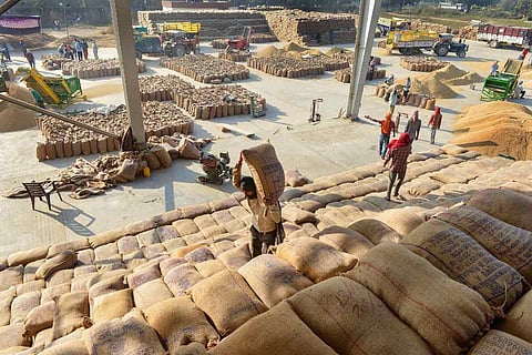 Representative image of workers at a grain market