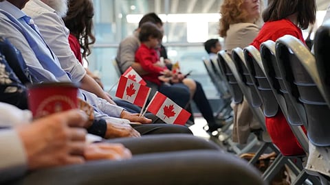 Soon-to-be new Canadians listen during a citizenship oath ceremony on Canada Day on July 1, 2019 at the Calgary International Airport.