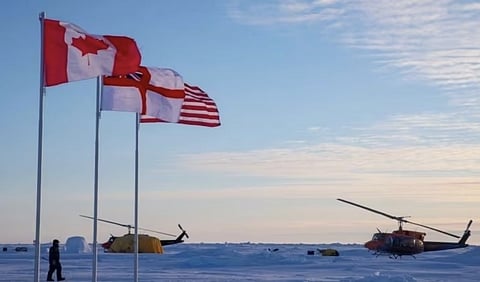Flags of Canada, the Royal Navy and the United States, at an Arctic location
