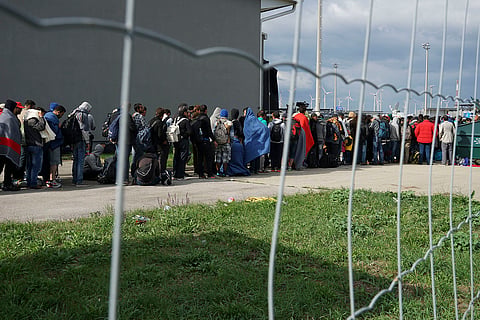 A line of Syrian refugees crossing the border of Hungary and Austria on their way to Germany on September 6, 2015. 