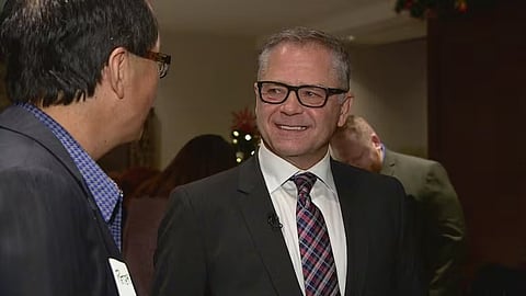 Conservative MP Len Webber speaks to a supporter during a holiday reception in his Calgary constituency in December 2019. 