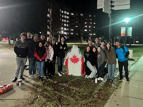 University of Calgary students painting Remembrance Day rocks