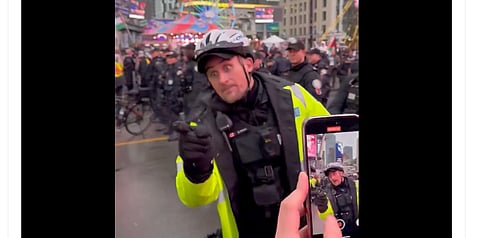 Toronto cop warns protester he will take his Canadian flag