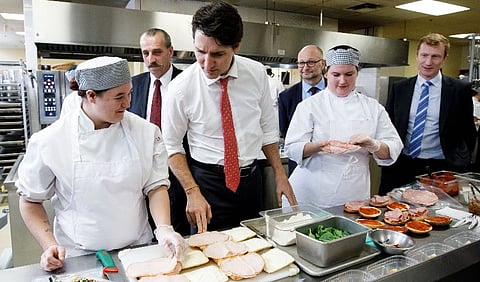 Happier days for the Liberals... Prime Minister Justin Trudeau and Justice Minister Lametti (centre background) visit a Montreal kitchen. MP Marc Miller (now Minister of Immigration) on the right. 