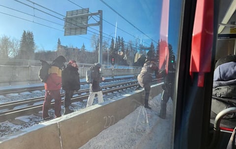 C-Train passengers leave a stalled train near Sunalta Station on Friday morning after waiting in -36C weather for one-and-a-half hours. 