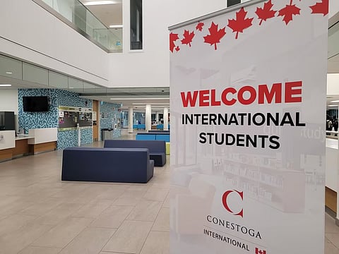 A sign at the downtown Kitchener campus of Conestoga College welcomes international students.