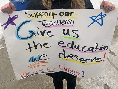 Regina student holds sign at walkout in support of Saskatchewan teachers held at the Saskatchewan legislature, February 2, 2024