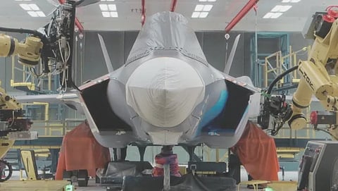 An Aerobotix mobile robot places a mold on the F-35 Lightning II.