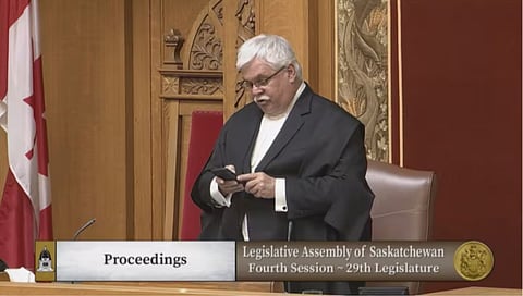 Speaker Randy Weekes reads a text message from Finance Minister Donna Harpauer into the record