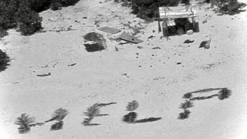 Three castaways were rescued from a deserted atoll in Micronesia after spelling ‘HELP’ in the sand.
