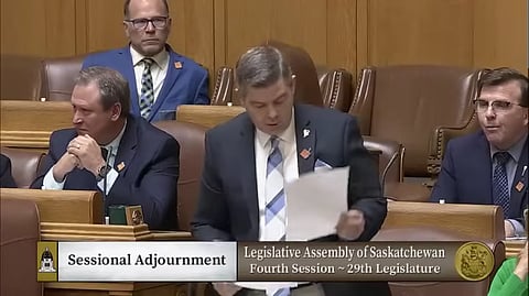 Jeremy Harrison, seen here making a motion to adjourn the Saskatchewan legislature on May 16, resigned as Government House Leader following revelations he brought a rifle to the legislature