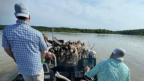 Jordan Chrestman and Brad Carlisle with dogs on the boat. 