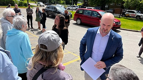 NDP MLAs Meara Conway and Matthew Love speak with concerned residents at a media event in Saskatoon