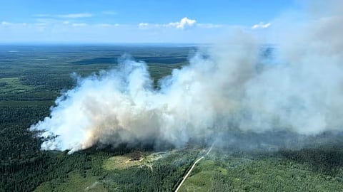 Smoke rises from an out-of-control wildfire in the Edson Forest Area on July 10, 2024. 
