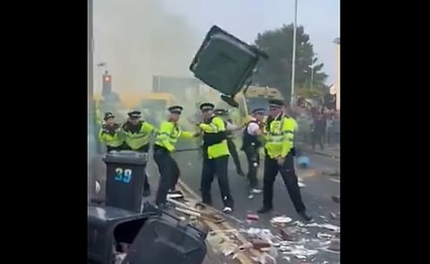 Wheelie bin thrown at British police officers. 