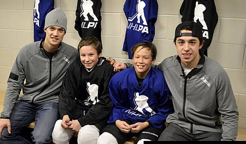 Johnny Gaudreau (right) in Cochrane in 2015 for KidSport Alberta to donate $25,000 in new hockey equipment for peewee hockey.