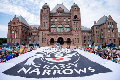 Supporters of Grassy Narrows First Nation members demand justice for the ongoing mercury contamination in the community. 