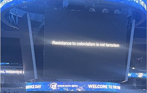 A slogan displayed on a scoreboard at the Canada Life Centre saying "Resistance to colonialism is not terrorism." 