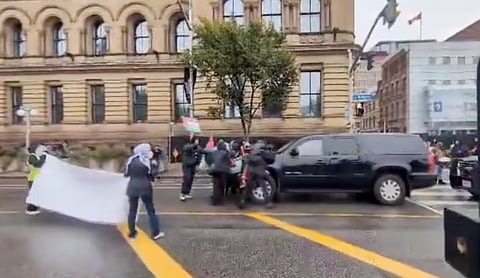 Pro-Palestine protestors swarmed an RCMP vehicle near Justin Trudeau's office and tried to push it back. 