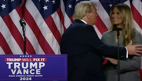 Re-elected President Donald J. Trump embraces (and then kisses) his wife Melania, during his victory speech last night