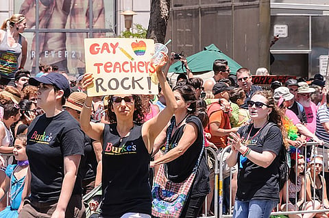 A teacher participates in a Pride event. 