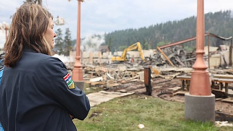 Premier Danielle smith looks at the fire damage in Jasper