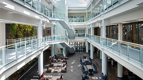 The impressive atrium at St. Mary's University. Retired education professor Patrick Keeney points to a less impressive feature, the university's oppressive application of DEI principles
