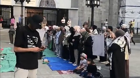 Muslim prayer in front of a Montreal church