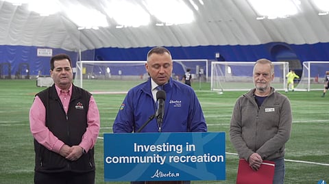 Minister Andrew Boitchenko speaking at a press conference in Edmonton. 