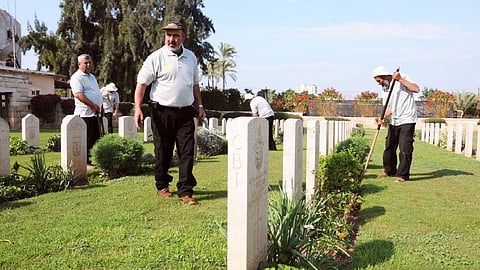Workers at the CWGC Cemetery in Gaza City, before it's destruction