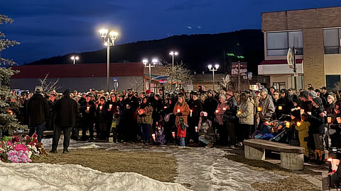 Tumbler Ridge residents holding candles at a vigil for victims of Tuesday's shooting. 