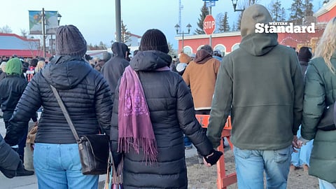 Tumbler Ridge residents holding hands in unity as they stand together following Tuesday's shooting at Tumbler Ridge Secondary School. 