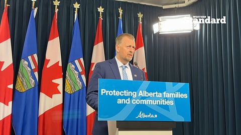 Minister of Public Safety and Emergency Services Mike Ellis speaking to reporters.