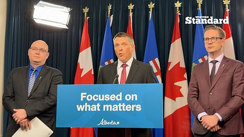 Finance Minister Nate Horner speaking to reporters with and Minister Nate Glubish and Minister Searle Turton.