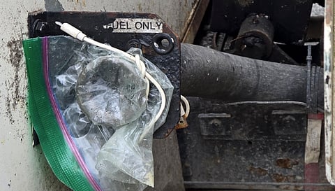 Fuel cap held by sandwich bag and charging cable highlights Burnaby truck crackdown