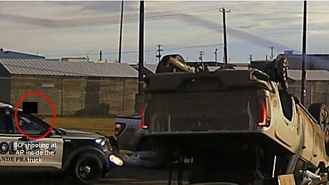 RCMP officer, circled, opens fire on gunman