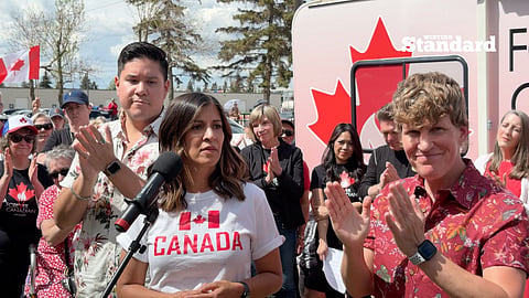 Rakhi Pancholi speaking at the Forever Canadian event with Janis Irwin and Brooks Arcand-Paul by her side. 