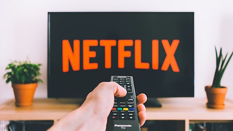 Netflix’s record revenue and price hikes portend an economic crash warns economist.