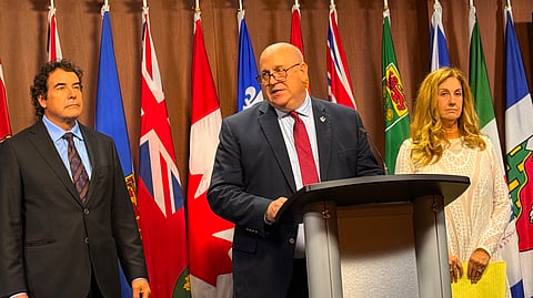 MP Dean Allison speaking (center)