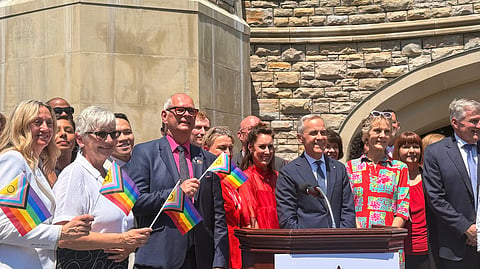Liberal MPs and Prime Minister Mark Carney (standing center right) next to his wife Diana Fox Carney at Pride flag ceremony