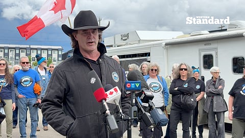 Corb Lund addresses members of the media at a "Water Not Coal" protest. The demonstration opposes coal mining developments in Alberta.