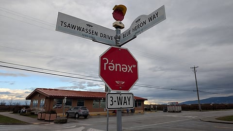 Stop signs featuring the hən̓q̓əmin̓əm̓ word “ʔə́nəxʷ” for “stop” stand at the intersection of Tsawwassen Drive and Blue Heron Way on Tsawwassen First Nation lands in Delta. The signs were installed last fall as part of British Columbia’s “indigenous language revitalization efforts.”