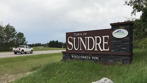 The Town of Sundre sign seen as individuals drive into the town. 